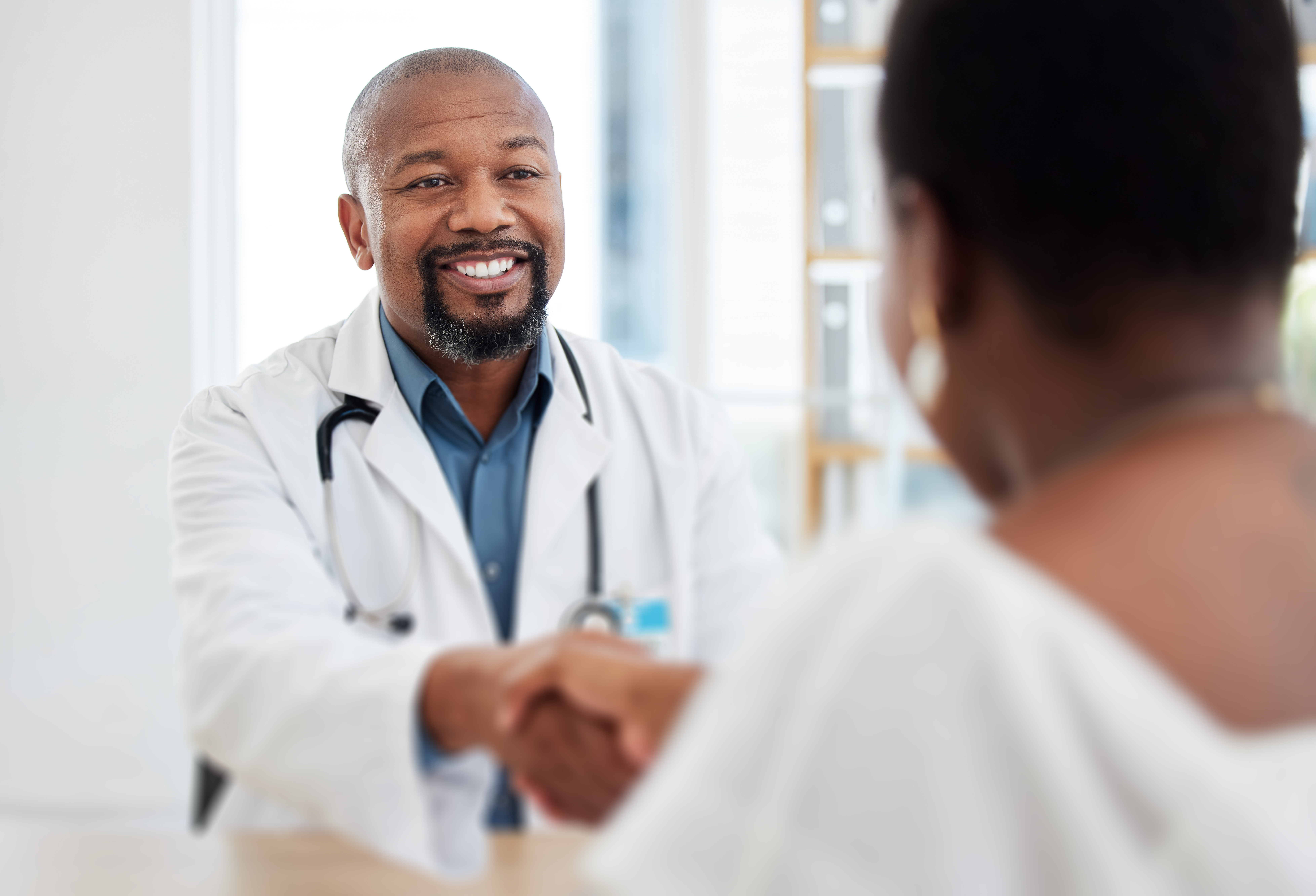 provider shaking hands with a patient
